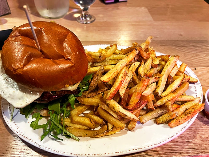 This isn't just any burger – it's a masterpiece on a bun, served with perfectly golden fries that look like they've been touched by King Midas himself. Photo credit: Phat Nguyen