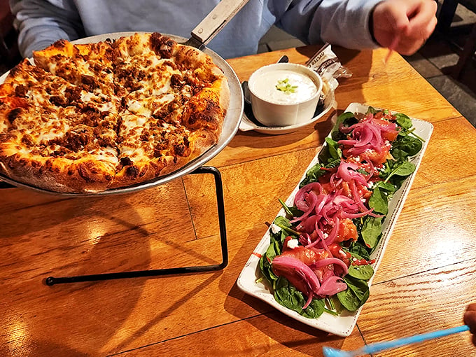 This wood-fired pizza arrives looking like a work of art, accompanied by a salad that's definitely not playing a supporting role. Photo credit: Zhang Ranran