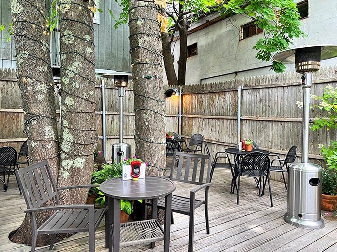 This secluded outdoor patio, complete with heat lamps and towering trees, offers a peaceful escape from Bar Harbor's bustling streets.