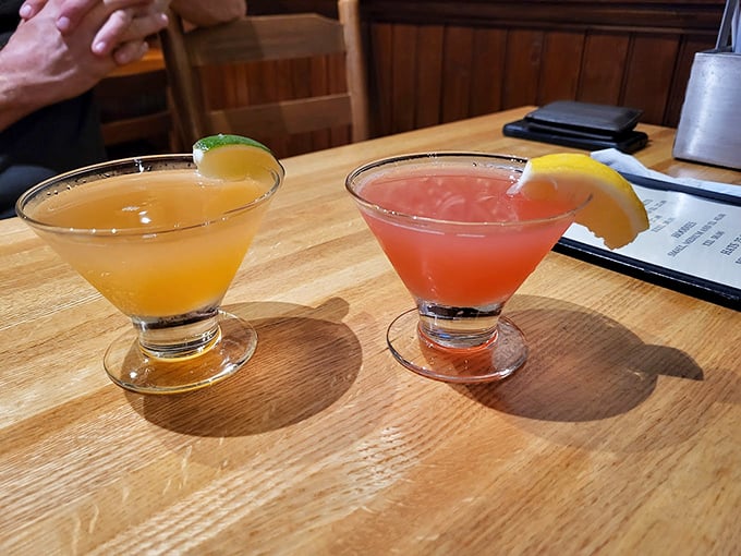 Two perfectly crafted cocktails catch the light, promising refreshment after a day of coastal adventures.