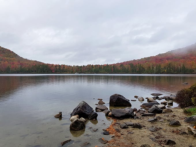 Mirror, mirror on the pond! Kettle Pond's glassy surface reflects autumn's fiery palette like nature's own Instagram filter.