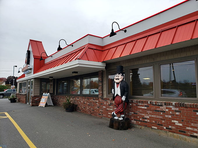 Welcome to Governor's, where the red roof beckons like a lighthouse guiding hungry sailors to comfort food shores. That dapper statue? He's the unofficial greeter, ready to tip his hat to your appetite.