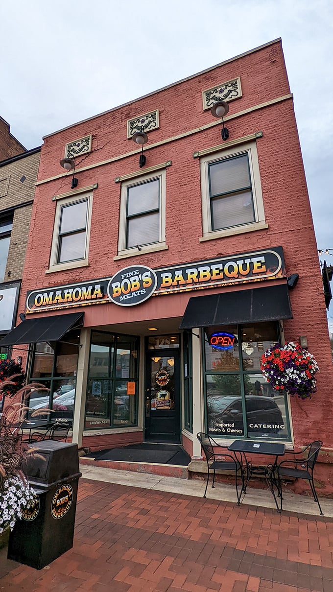 A barbecue beacon in brick and mortar! Omahoma Bob's stands proud, its awning a promise of smoky delights within. Flower baskets add a touch of charm to this meat-lover's paradise.