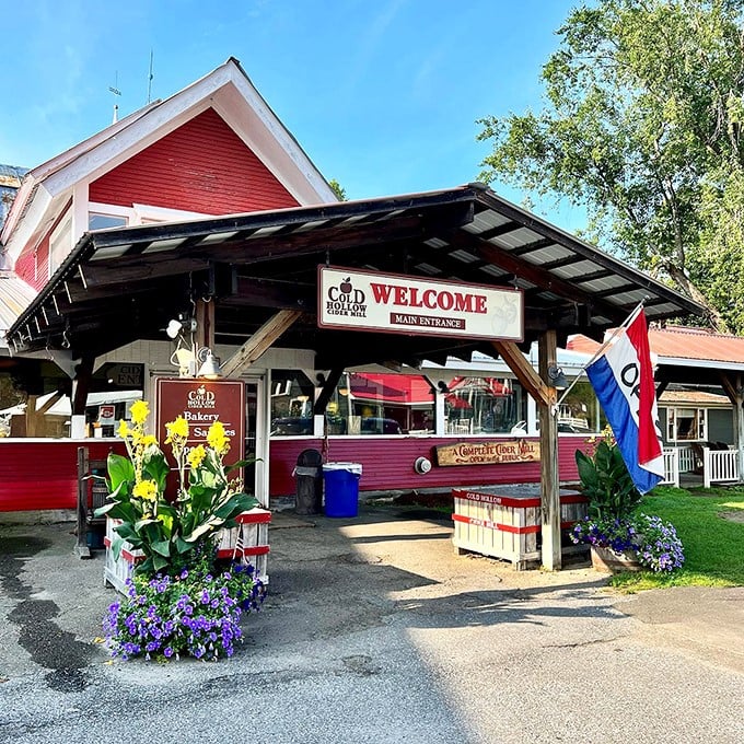 Welcome to apple paradise! Cold Hollow Cider Mill's charming red exterior beckons like a siren song to cider lovers and donut enthusiasts alike.