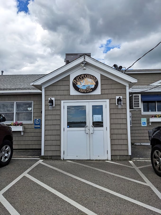 A classic New England seafood shack with weathered shingles and a welcoming sign - Billy's Chowder House promises coastal comfort at its finest. Photo credit: Anne Chenoweth-Ruble