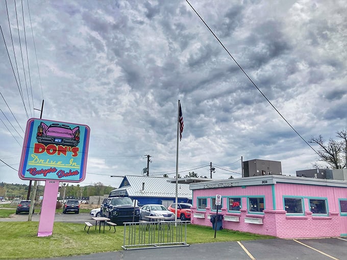 A pink paradise awaits! Don's Drive-In stands proud against the Michigan sky, its neon sign a beacon for hungry time-travelers and modern-day foodies alike.