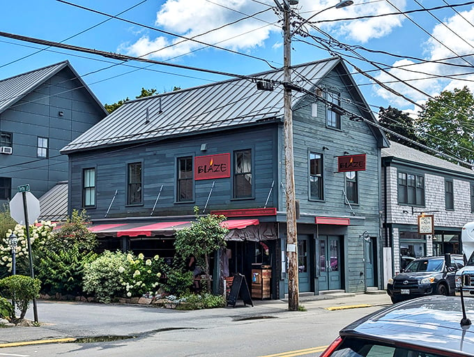 This charming gray building with red accents stands like a friendly lighthouse for hungry souls in Bar Harbor, beckoning passersby with promises of culinary delights. Photo credit: iVes Winzy (Williams)