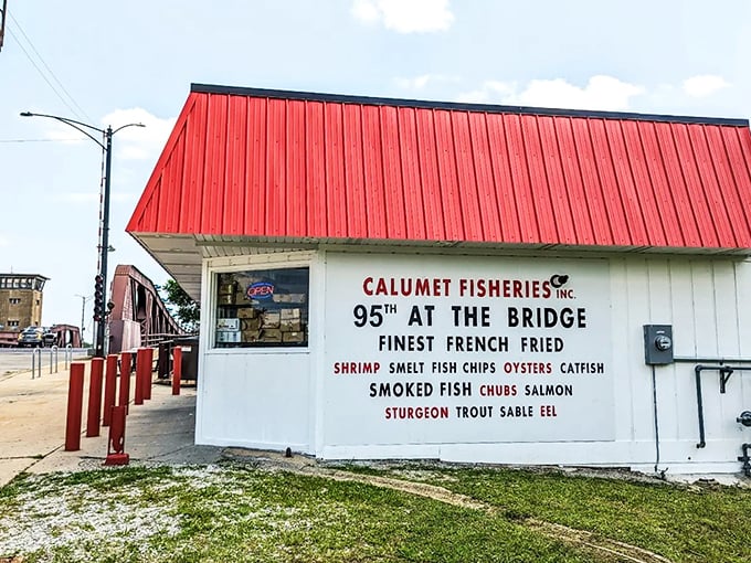 A red-roofed beacon of seafood salvation! Calumet Fisheries stands proud at the bridge, promising smoky delights that'll make your taste buds do a happy dance.