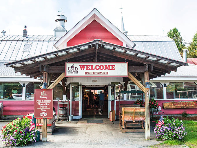 Welcome to apple paradise! Cold Hollow Cider Mill's charming red exterior beckons like a siren song to cider lovers and donut enthusiasts alike.