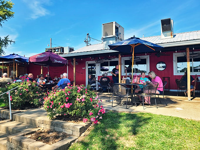 A red-hot destination! The Boat House's vibrant exterior and blooming flower beds invite you to dive into a world of riverside dining delights.