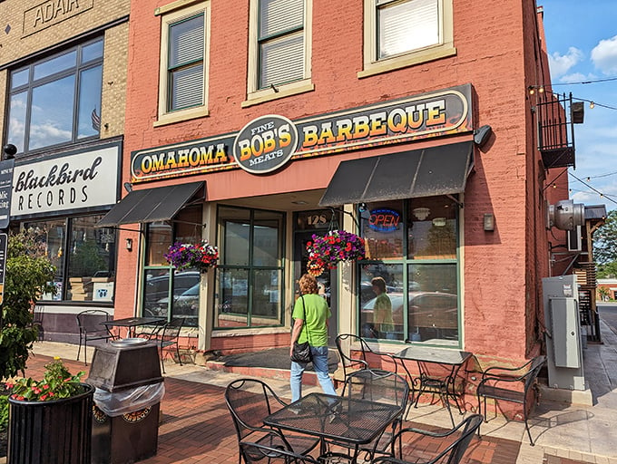 A barbecue beacon in brick and mortar! Omahoma Bob's stands proud, its awning a promise of smoky delights within. Flower baskets add a touch of charm to this meat-lover's paradise.