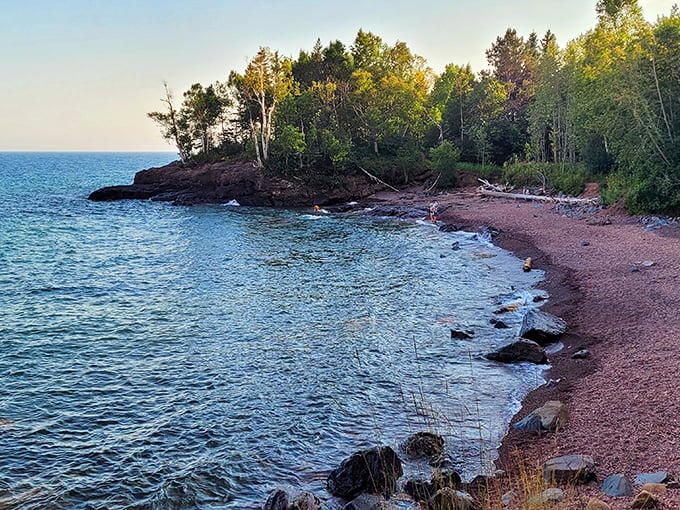 Nature's own infinity pool! Iona's Beach stretches out like a rosy welcome mat, inviting you to dip your toes in Lake Superior's crystal-clear waters.