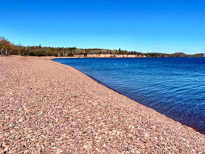 Nature's own infinity pool! Iona's Beach stretches out like a rosy welcome mat, inviting you to dip your toes in Lake Superior's crystal-clear waters.