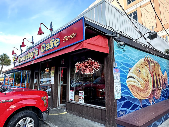 Welcome to flavor town! Frenchy's vibrant exterior, complete with a giant fish mural, promises a seafood adventure that'll make your taste buds do the cha-cha.