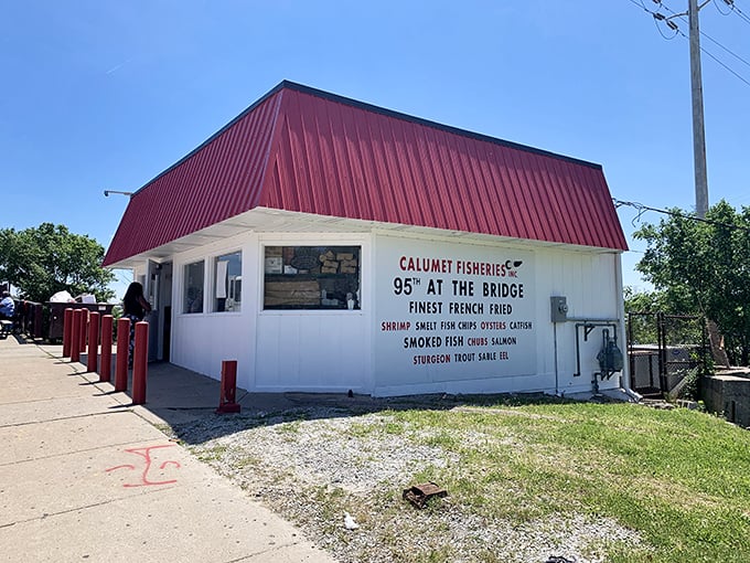 A red-roofed beacon of seafood salvation! Calumet Fisheries stands proud at the bridge, promising smoky delights that'll make your taste buds do a happy dance.