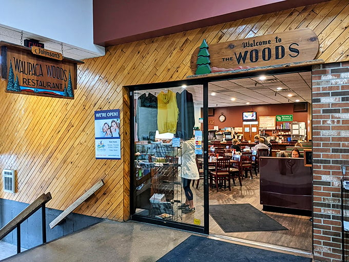 Welcome to the Woods! This cozy entrance is like a warm hug from your favorite lumberjack uncle, inviting you into a world of comfort food and charm.