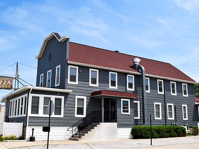 Fricano's: Where time stands still, but the pizza oven keeps on turning. This charming gray building serves up slices of nostalgia with a side of small-town charm. Photo credit: Fricano's Pizza Tavern