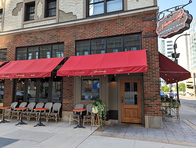 Step into a Parisian postcard! Red awnings and wicker chairs invite you to sip, savor, and people-watch like a true flâneur.