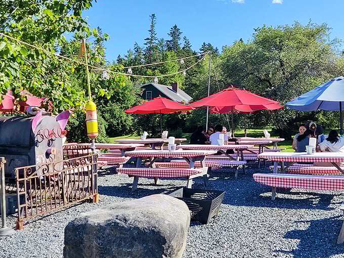 Red-checkered tables under bright umbrellas, with a lighthouse standing guard. Summer dining doesn't get more quintessentially coastal than this. Photo credit: Lijun Zhou