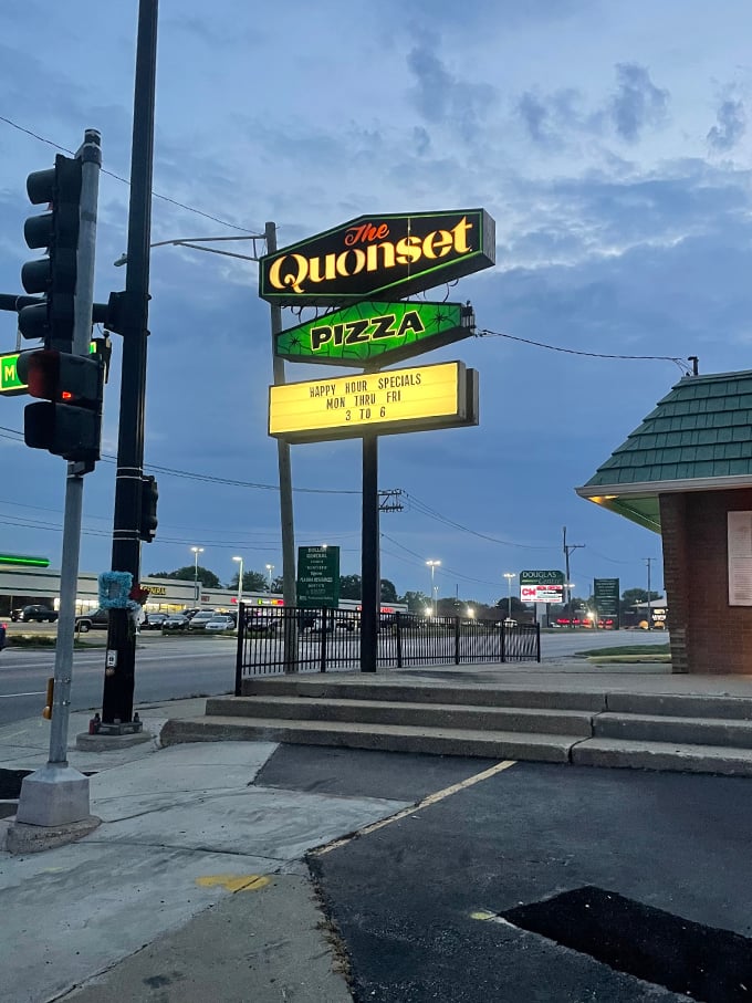 The sign that beckons pizza lovers from far and wide. It's like a lighthouse for the hungry, guiding you to a safe harbor of deliciousness.