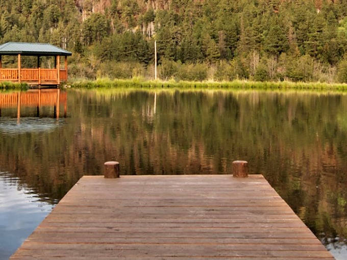 Tranquility, party of one? Your lakeside seat awaits. Just add a good book and watch your worries drift away on the glassy surface.