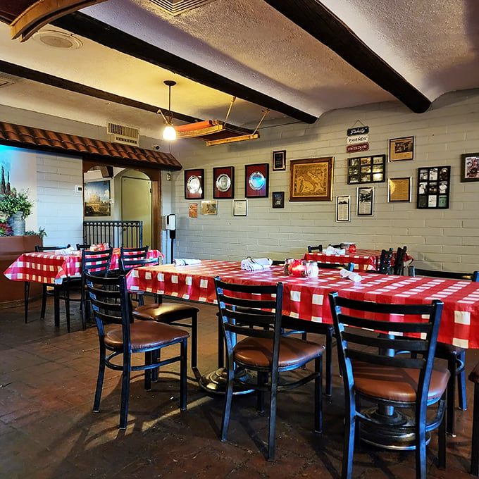 Red and white checkered tablecloths under exposed wooden beams - because some traditions just know how to make you feel at home.