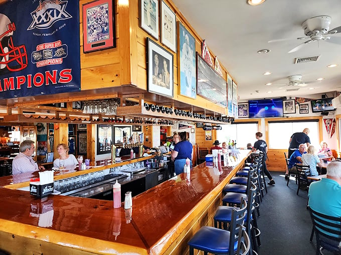 The bar area feels like your favorite neighborhood spot, complete with Patriots memorabilia and the warm glow of Maine hospitality. Photo credit: Miguel Salinas