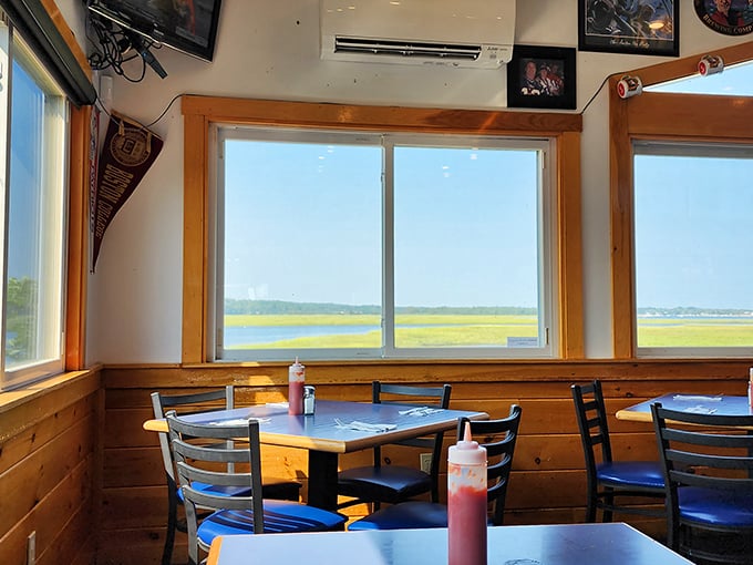 Sun-drenched windows frame the marsh like nature's own HDTV, while wooden tables invite you to stay awhile and soak it all in. Photo credit: Betsy Gotch