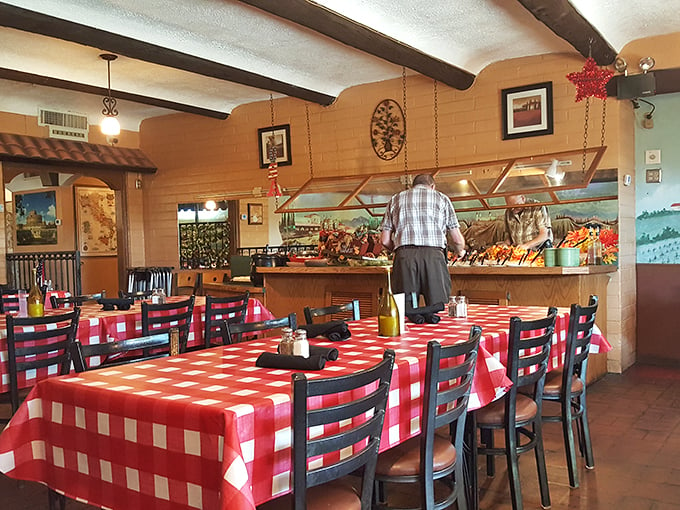 Classic red and white decor meets cozy booth seating - where countless family stories have unfolded over plates of pasta.