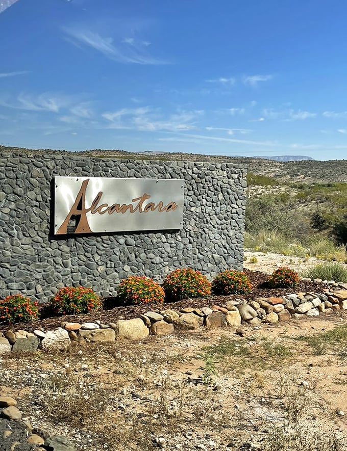 Your GPS isn't lying – you've arrived at wine paradise. This entrance sign marks the spot where desert dreams and vineyard realities collide in delicious harmony.