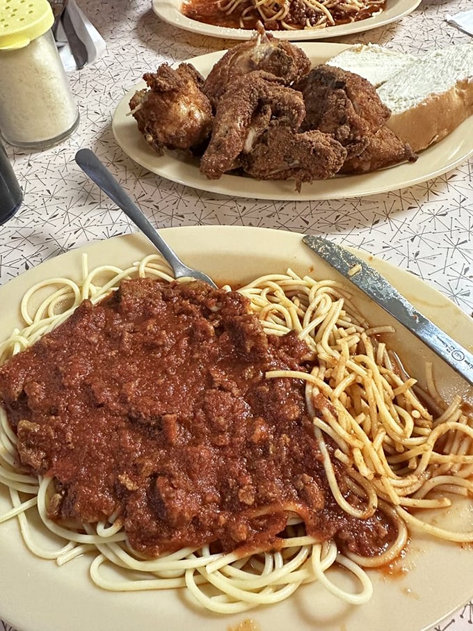 Spaghetti swimming in a sea of meaty sauce, with meatballs as big as your childhood dreams. Napkins are not optional!