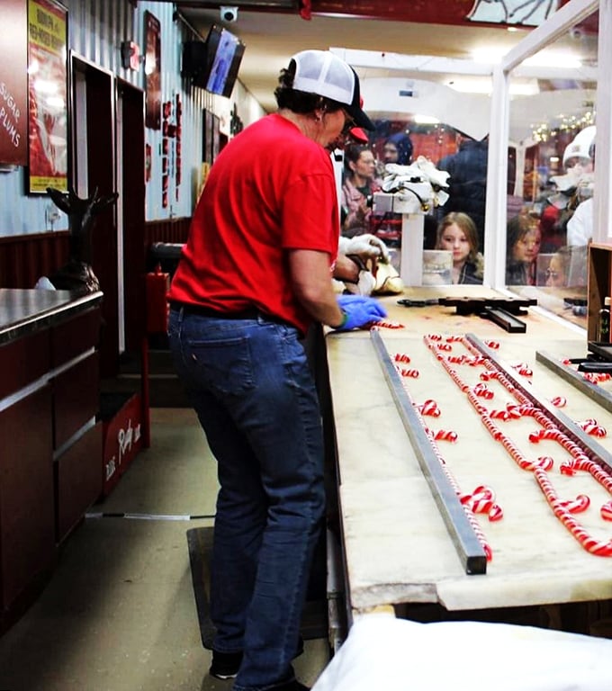 Candy cane assembly line: Where elves earn their stripes. Willy Wonka, eat your heart out!