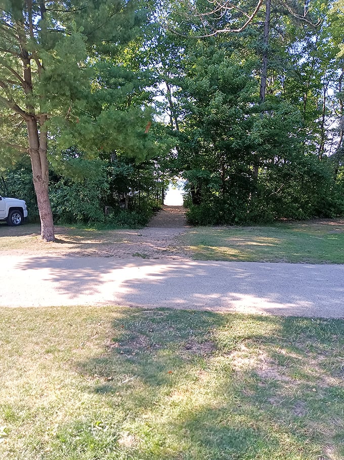 Nature's VIP entrance: Where the trees part to reveal Lake Superior's grand stage. Red carpet not required, sandy feet welcome.