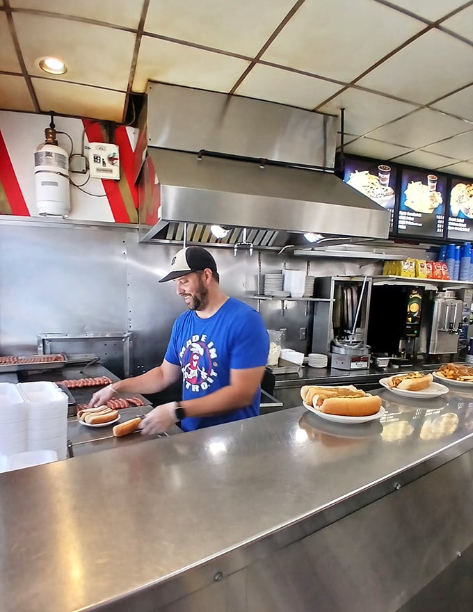 Watch the maestro at work! This grill master could teach Gordon Ramsay a thing or two about hot dog artistry.