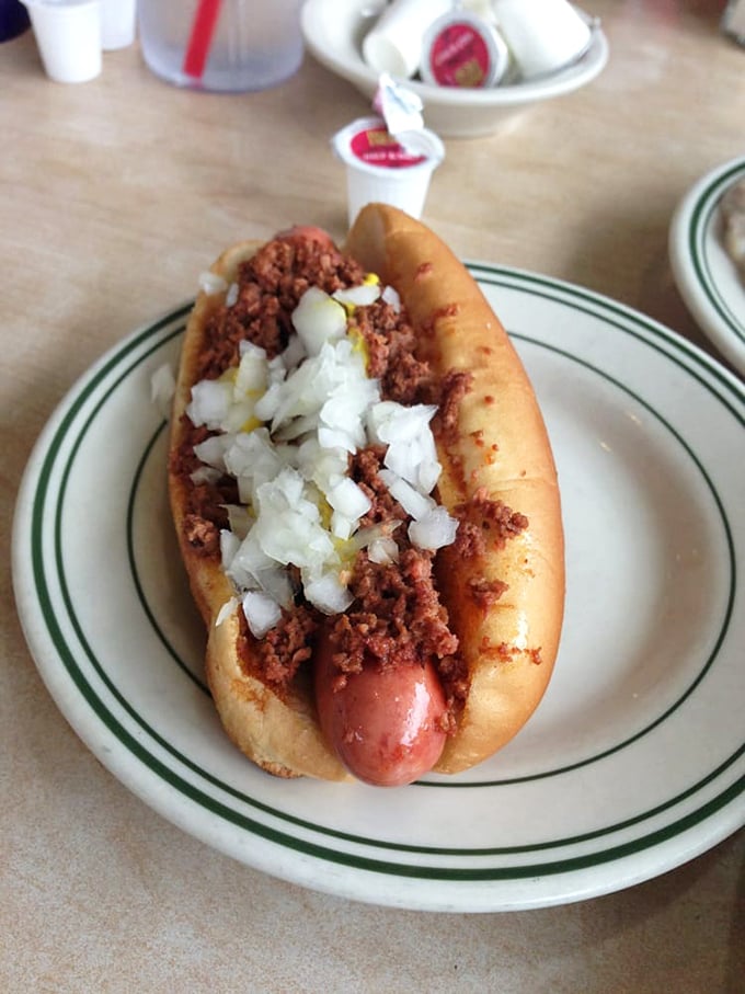 Behold, the Flint-style coney in all its glory! This isn't just a hot dog, it's a meaty masterpiece that puts the 'comfort' in comfort food.