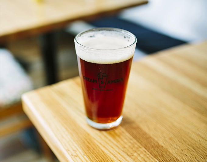 Cheers to good books and great beer! This amber beauty is like liquid sunshine in a glass, perfect for sipping while pondering life's great mysteries... or just relaxing.