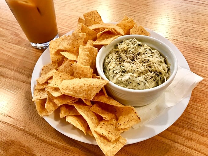 Chip, chip hooray! This spinach dip looks so creamy and inviting, you might forget you're eating vegetables. It's like a warm hug for your taste buds.