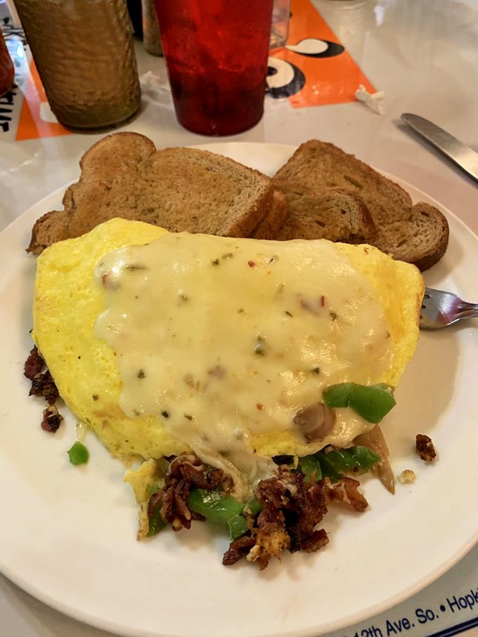 This omelet is so fluffy, it might float away if not anchored down by a generous blanket of melted cheese.