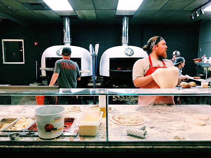 Pizza wizards at work! These culinary conjurers are turning dough into dreams right before your eyes.