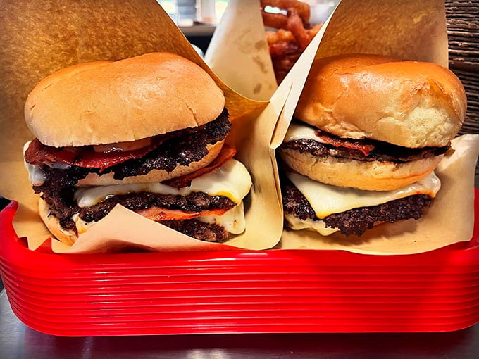 Double patties, melted cheese cascading like a waterfall, and bacon that could make a vegetarian question their life choices. Photo credit: Backwoods Burger Shack