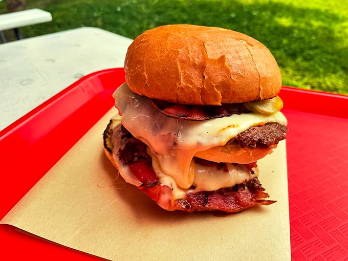 This triple-decker burger is stacked higher than a Maine pine tree, with cheese melting down its sides like summer sunshine. Photo credit: Backwoods Burger Shack