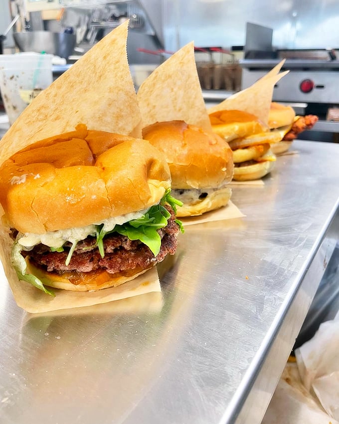 These burgers lined up like soldiers of satisfaction, each one ready to serve in the battle against hunger. Photo credit: Backwoods Burger Shack