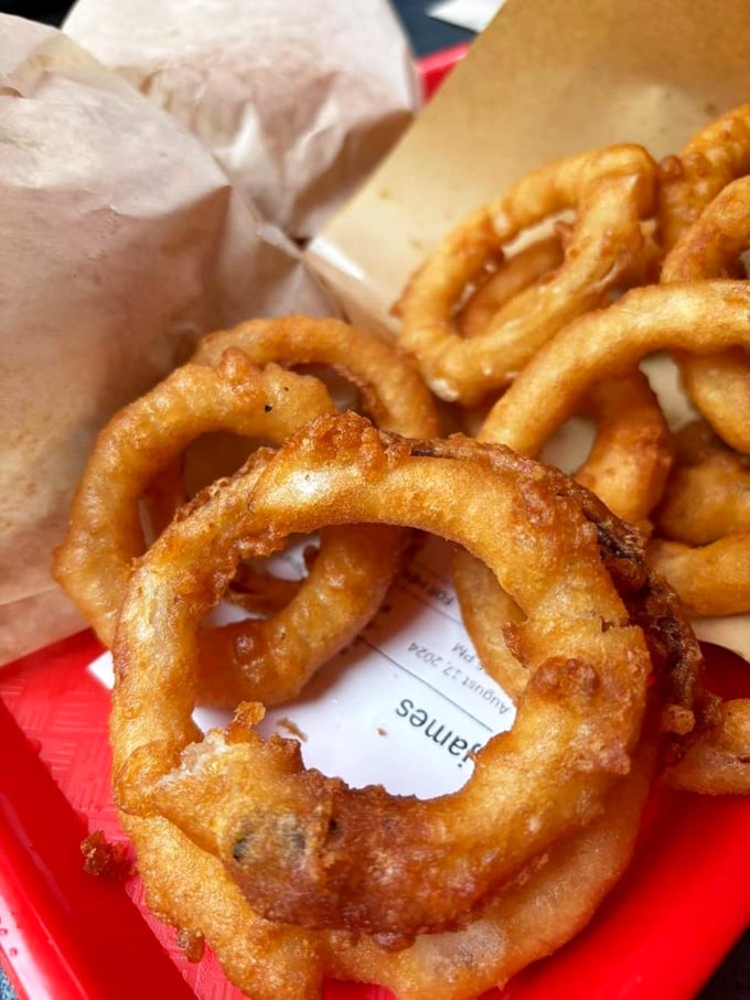 Crispy, golden onion rings that crunch louder than autumn leaves – the perfect sidekick to any burger adventure. Photo credit: Rick B.