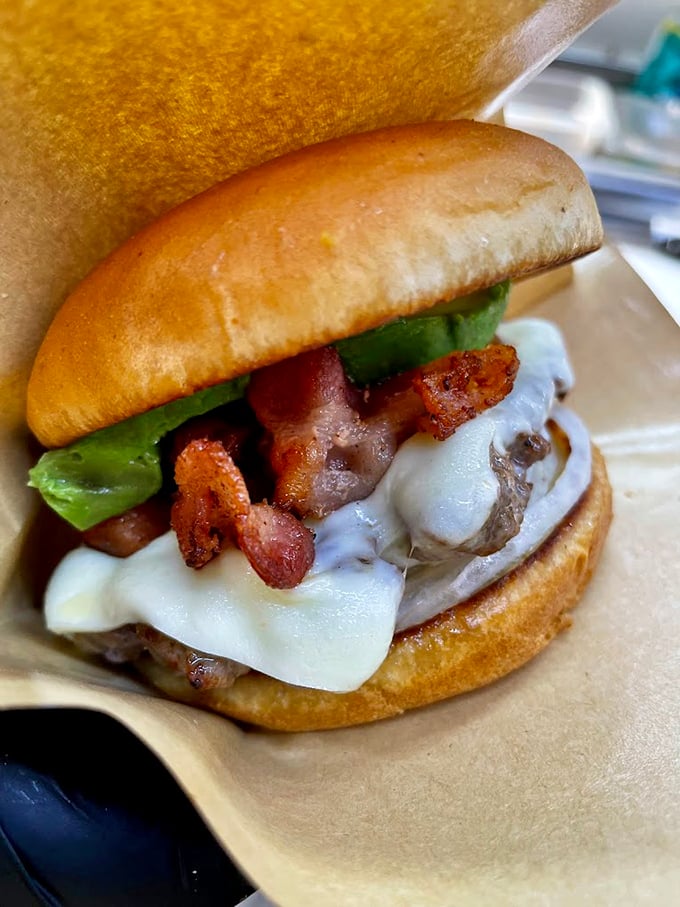 Bacon and cheese unite on this burger like old friends at a backyard barbecue, creating pure handheld happiness. Photo credit: Backwoods Burger Shack