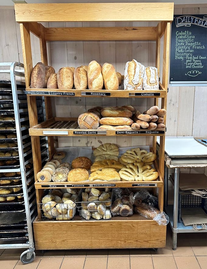 A bread display that could make a carb-counter weep with joy, featuring everything from crusty baguettes to artisanal loaves. Photo credit: Alon G.