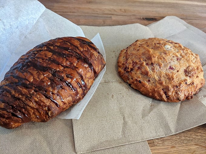 Two breakfast champions: a chocolate-drizzled croissant and rustic scone ready to start your day on a deliciously high note. Photo credit: Olga S.