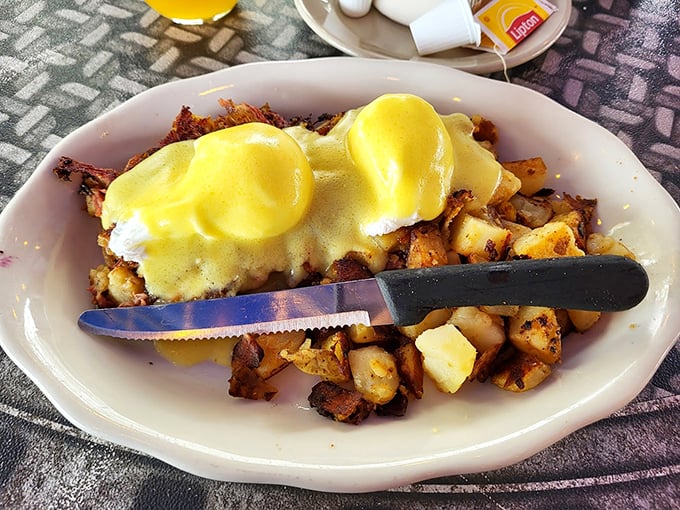 Eggs Benedict done diner-style: perfectly poached eggs lounging on a bed of crispy potatoes. Photo credit: Jay s