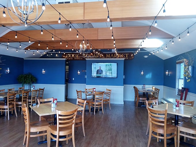 String lights dance across wooden beams while nautical blue walls create the perfect backdrop for memorable Maine dining moments. Photo credit: Stayc