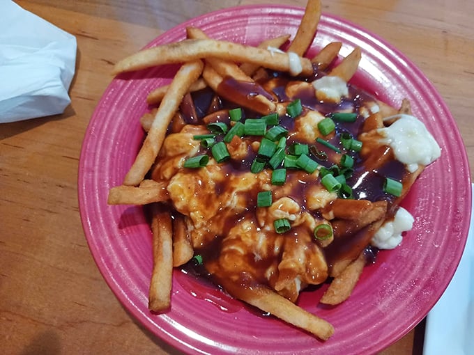 Golden fries drowned in savory sauce and topped with fresh scallions - comfort food gets a gourmet makeover. Photo credit: Pat Carver