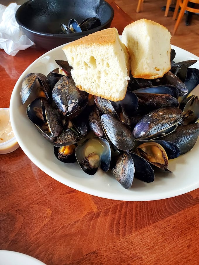 Fresh mussels steamed to perfection, served with crusty bread perfect for soaking up every last drop of broth. Photo credit: Rachel Wing